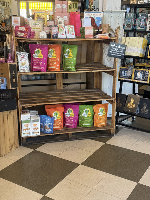 Cactus Corn popcorn merchandised with Southwest books and Arizona gifts on a rustic wood gift shop shelf