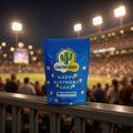 Happy Birthday Cake popcorn bag from Cactus Corn on a stadium railing during a night ballgame
