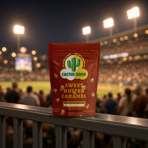 Sweet Butter Caramel popcorn bag from Cactus Corn on a stadium railing during a night ballgame